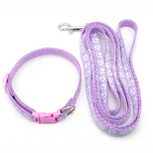 Set collare e guinzaglio per animali domestici viola con stampa di zampe per passeggiate.