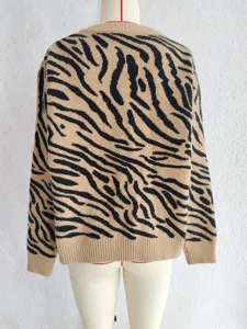 Detailed view of women's long sleeve knit sweater featuring a stylish brown zebra pattern design.