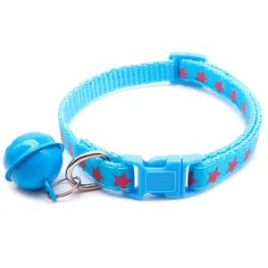 Close-up of blue pet collar detail, featuring pink stars print and a large blue bell accessory.