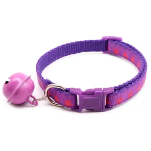Purple pet collar detail showing large bell and secure plastic buckle for cats and dogs