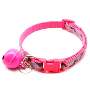 Close-up detail of the pink camo pet collar highlighting the durable buckle, ring, and cute bell.