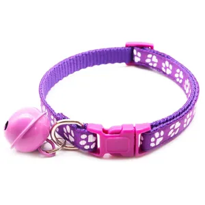 Purple pet collar with paw prints and bell, nylon material for small dogs and cats, detail view.