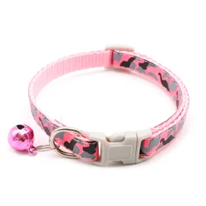 Detailed close-up shot of the pink camo pet collar highlighting the secure buckle and bell.