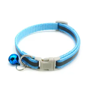 Blue reflective pet collar detail shot, showing safety buckle, metal D-ring and blue bell.