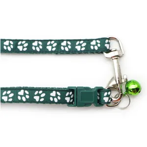 Green pet collar leash with white paw print pattern, metal hardware and bell for cats and dogs.