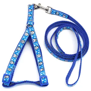 Detailed shot of blue pet harness and leash set with cute cartoon dog print and metal buckle.