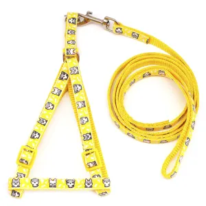 Yellow pet harness and leash set with cute cartoon cat patterns, adjustable straps for small dogs.