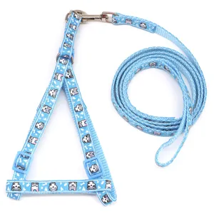 Closeup of blue cat harness and leash set featuring cute kitten print and durable metal hooks.