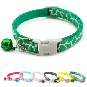Green pet collar detail showing durable nylon strap, plastic quick-release buckle, and matching bell.