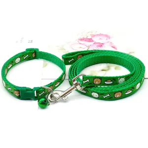 Green pet collar and leash set with cute cartoon dog pattern, bell and metal hook for small pets.