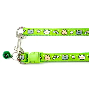 Green pet collar with cute cartoon animal prints, plastic buckle, bell, and metal hook for cats.