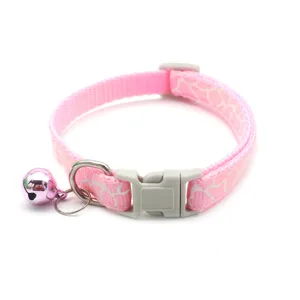 Pink cat collar with white crackle pattern, grey plastic buckle, metal D-ring, and cute pink bell.