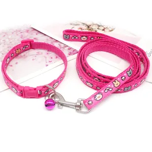 Pink pet collar and leash set with cute cartoon animal prints, plastic buckle, and bell.