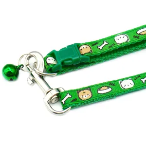 Green pet leash detail shot showing durable nylon strap, metal hook, buckle, and cute bell accessory.
