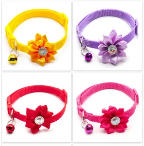 Detailed view of colorful pet collars featuring fabric flowers and bells in four variants.