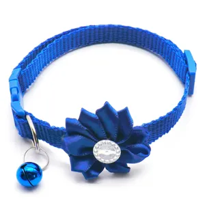 Blue pet collar with fabric flower rhinestone decor and bell detail for cats and small dogs.