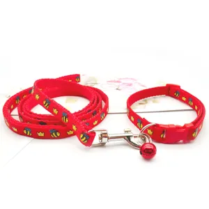 Red cartoon bee print pet dog leash and collar detail, cute puppy walking accessory set.