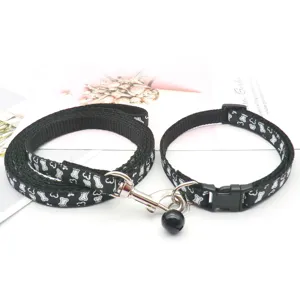 Detailed view of black bone pattern pet collar and leash set with metal clasp and bell.