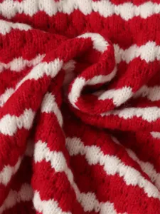 Red and white striped knit sweater fabric detail view, comfortable soft texture for autumn.