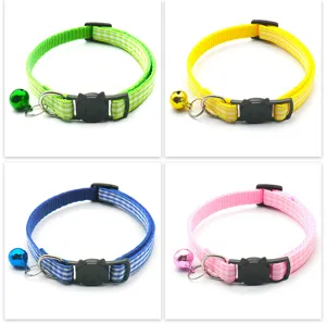 Close up of colorful plaid cat collar details, featuring cute cat face buckle and small bell.