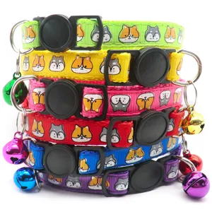 Close-up detail of colorful pet collars featuring cute cartoon animal prints and metal bells.