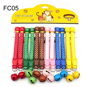 Close-up details of colourful polka dot pet collars with bells and secure plastic buckles display.