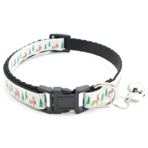 Close-up detail of Christmas pet collar with cute reindeer print, bell, and secure buckle.