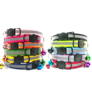 Close-up of colorful reflective pet collars with safety buckles and bells for cats and dogs.