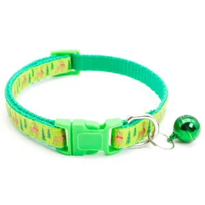 Close-up detail of green Christmas pet collar with festive reindeer pattern and bell.