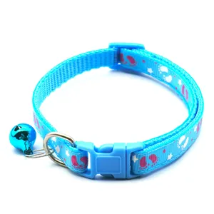 Closeup of blue pet collar detail, featuring cute footprint print, safety buckle and clear bell.