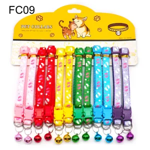 Detailed view of colorful printed pet collars with bells and cute footprint patterns.