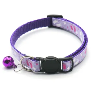 Purple pet cat collar with safety buckle, cute footprint pattern and bell, ideal for pets.