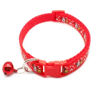 Close-up detail of the red pet collar featuring cute cartoon prints, plastic buckle, and bell.