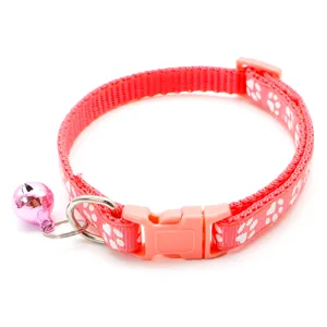 Pink pet cat dog collar with cute paw print design, adjustable buckle and sweet bell detail.