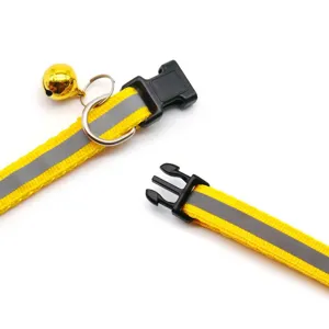 Close up of reflective pet collar strap, durable black plastic buckle and cute golden bell.