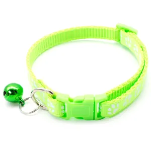 Green pet collar detail with cute paw print pattern, plastic buckle, and shiny bell.