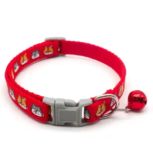 Red pet collar detail view, woven fabric strap with cute cartoon animals and metal bell.