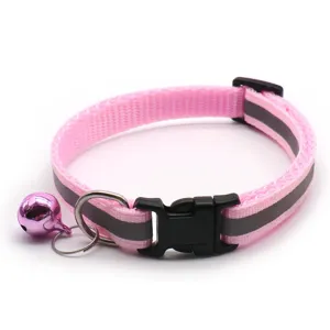Close-up of pink reflective pet collar with bell and buckle for cats and dogs details