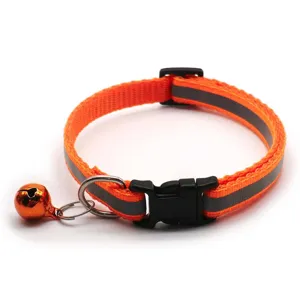Detailed view of reflective orange pet dog collar featuring metal bell and secure plastic buckle