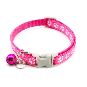 Pink paw print cat collar with bell and buckle, adjustable nylon pet collar for small dogs.