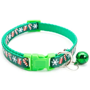 Christmas pet collar detail view, green festival pattern, bell and buckle close-up