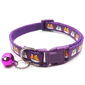 Close-up detail of the purple pet collar with cute cartoon animal prints and a bell.