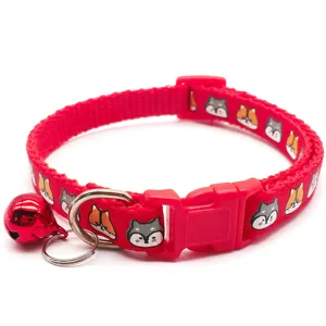 Detailed view of the red pet collar featuring cute cartoon animal prints, a bell, and buckle.