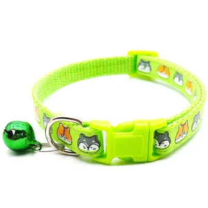 Green pet cat collar detail with cute cartoon print, safety buckle and bells for kittens.
