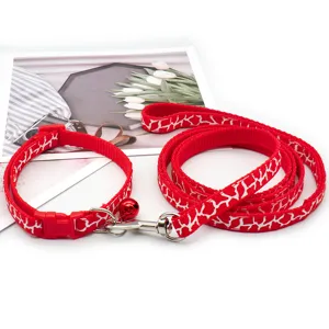 Red printed pet leash and collar set for small dogs with bell and metal hardware.