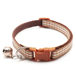 Brown and white checkered pet collar detail showing durable fabric strap and metal bell.