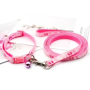 Pink pet collar and leash set with cute paw print pattern for small dogs and cats detail view.