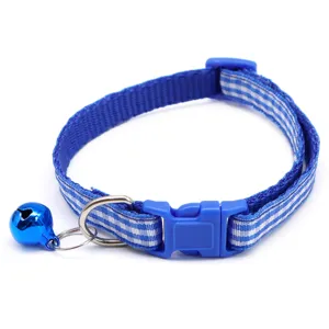 Close-up detail of the blue plaid pet collar with metal bell and durable plastic buckle.