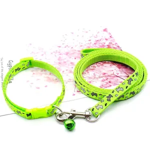 Green pet collar and leash set featuring cute dog pattern and metal bell for small dogs.