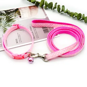 Pink polka dot pet collar and leash set detail, featuring secure buckle and lovely small bell.